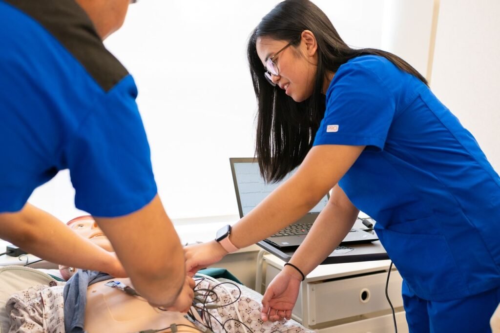 How to Become a Registered Nurse in California: From Licensing to Your First Job Nursing students practice using a medical mannequin in a simulation lab, focusing on patient care techniques.