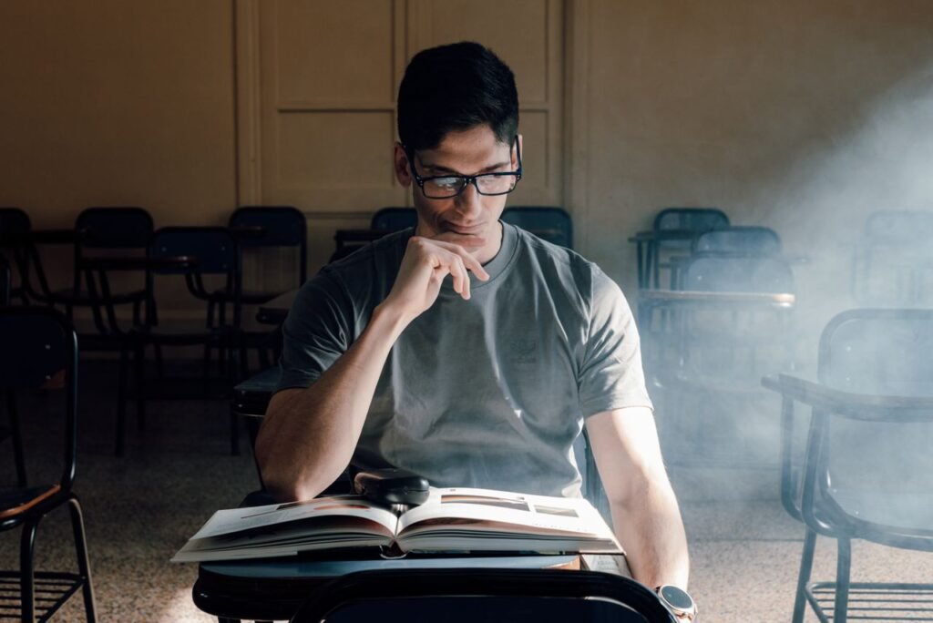 Can Immigrants Become Lawyers in the United States? Student reading a book in a sunlit classroom in Buenos Aires. Perfect for educational themes.