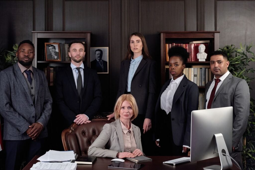 How Many Years of School Do You Need to Become a Lawyer? Diverse group of professionals in corporate attire posing confidently in an office environment.