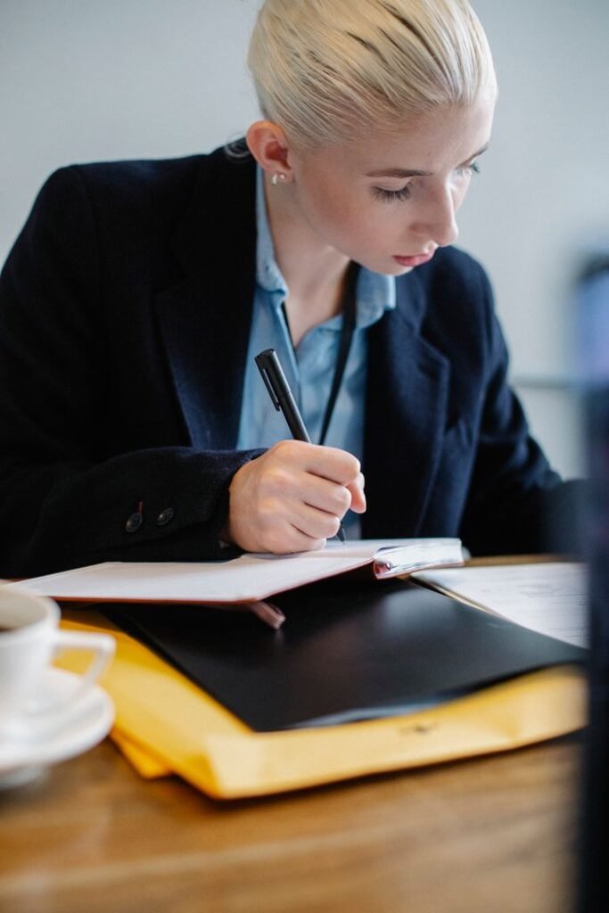 How to Ask for a Promotion (Without Feeling Awkward About It) woman preparing notes before asking for a promotion